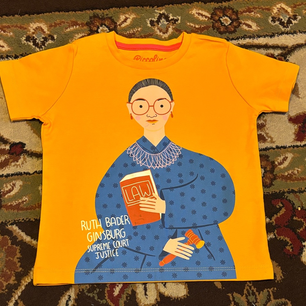 Piccolina Orange Shirt with Blue Justice Graphic